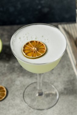 Limon ve şurupla alkollü köpüklü cin kokteyli.