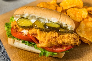 Southern Homemade Catfish Poboy Sandwich with Lettuce Tomato and Pickle clipart