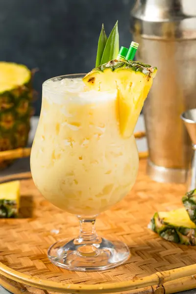 stock image Boozy Cold Pineapple Painkiller Cocktail with Coconut and Rum