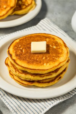 Homemade Breakfast Corn Cake Pancakes with Butter and Syrup clipart