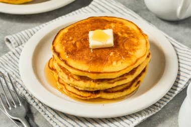 Homemade Breakfast Corn Cake Pancakes with Butter and Syrup clipart