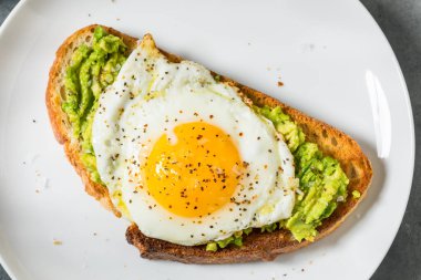 Kahvaltı için hafif yumurtalı ev yapımı Avokado tostu.