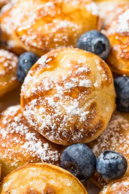 Homemade Danish Poefferjes Mini Pancakes with Powdered Sugar and Blueberries