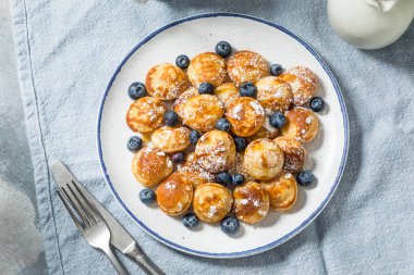 Homemade Danish Poefferjes Mini Pancakes with Powdered Sugar and Blueberries