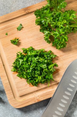 Raw Green Organic Minced Parsley on a Cutting Board