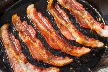 Greasy Cooked Thick Cut Bacon in a Skillet Pan