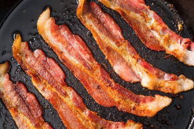 Greasy Cooked Thick Cut Bacon in a Skillet Pan