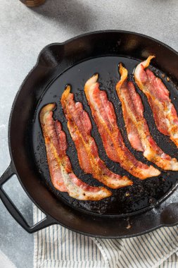 Greasy Cooked Thick Cut Bacon in a Skillet Pan