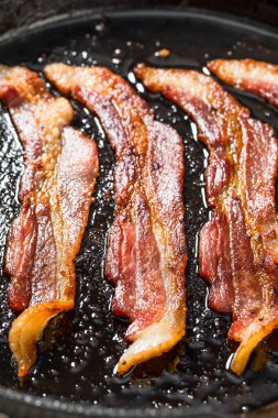 Greasy Cooked Thick Cut Bacon in a Skillet Pan