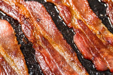 Greasy Cooked Thick Cut Bacon in a Skillet Pan