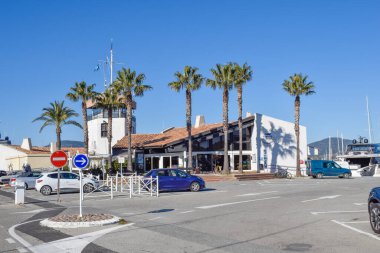 Port Cogolin winter day view yacht dock club marines building with palm trees