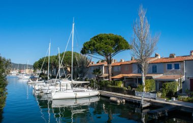 Port Cogolin house on river shore with yachts near the beach