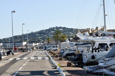 Path with yachts on port Cogolin harbor at daytime winter