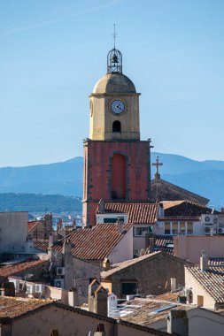 Saint Tropez church tower with clock against blue sky day time