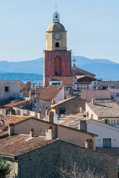 Saint Tropez church tower with clock against blue sky day time