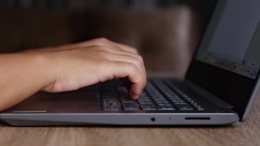 Laptop klavyesinde yazı yazan ellerin yakın çekimi. Uzaktan çalışma, serbest iş, dijital yaşam tarzı, çevrimiçi iletişim ve modern çalışma ortamı kavramı