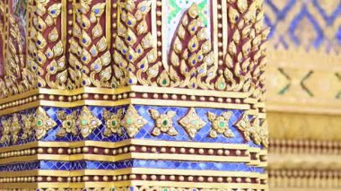 Public Thai temple architecture with traditional golden mosaic and colorful decoration for background, representing cultural heritage and public art in Thailand