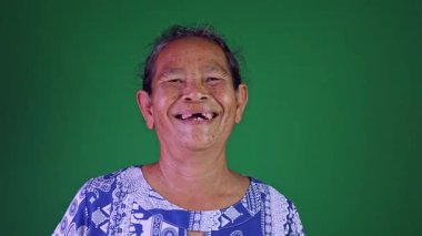 Elderly face woman laughing happy, Portrait elder with facial expression, Close-up portrait grandmother smiling happily on chroma key green screen background, Thai asian