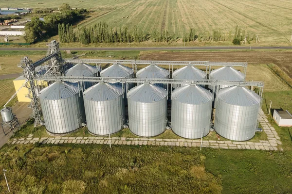 Storage facility for wheat grains after harvesting. Grain elevator aerial view and tank for wheat grain