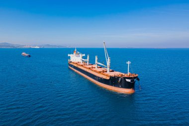 Aerial view of Dry bulk cargo ship in anchorage near commercial port clipart