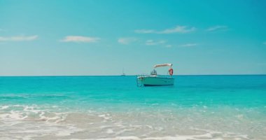 Motor Boat anchored off the beautiful beach Aegean sea, summer vacation concept