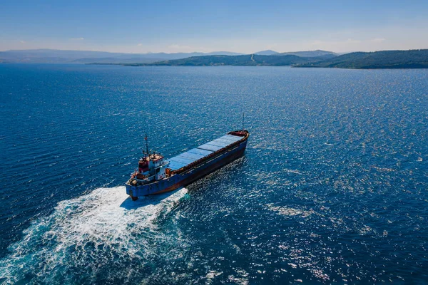 Bulk carrier vessel manoeuvring in sea, Aerial view