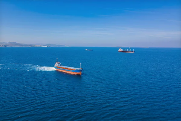 Cargo bulk vessel manoeuvring before entering port, aerial shot