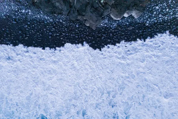 stock image Huge Atlantic ocean waves crash with foam on empty big stones beach. Aerial view