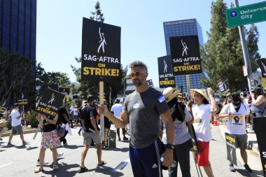 LOS ANGELES - AUG 4:  Strikers at SAG/AFTRA and WGA Strike at the Universal Studios on August 4, 2023 in Universal City, CA clipart
