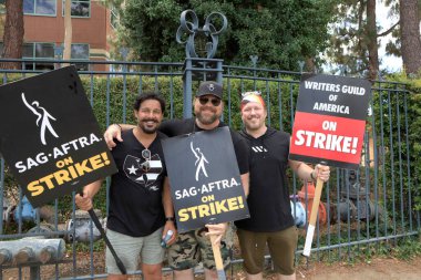 LOS ANGELES - AUG 1:  Jon Huertas, Drew Powell, Keith Andreen, Disney at SAG/AFTRA and WGA Strike outside at the Walt Disney Studios on August 1, 2023 in Burbank, CA clipart