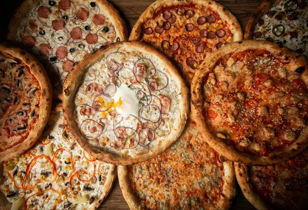lots of pizzas on top of each other, beautiful top view.