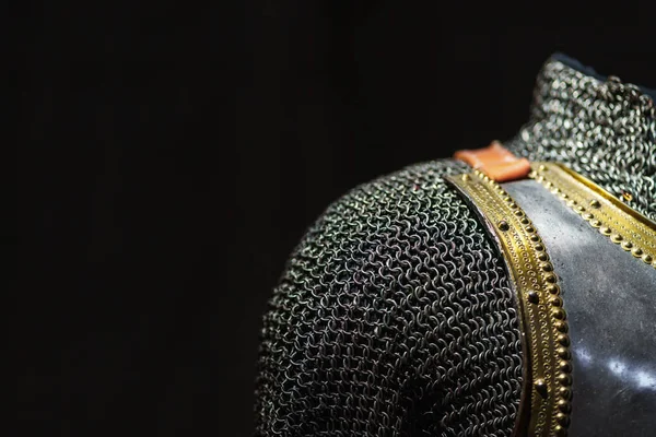 stock image Close-up and texture of a chain of handmade real chain mail armor, authentic armor of a medieval knight on a dark background, selective focus