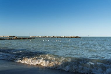 Huzurun özünü yakalayan bu kumsal, yumuşak dalgaları ve berrak gökyüzü, sükunet, kaçış ve doğanın zamansız cazibesine hitap eder.