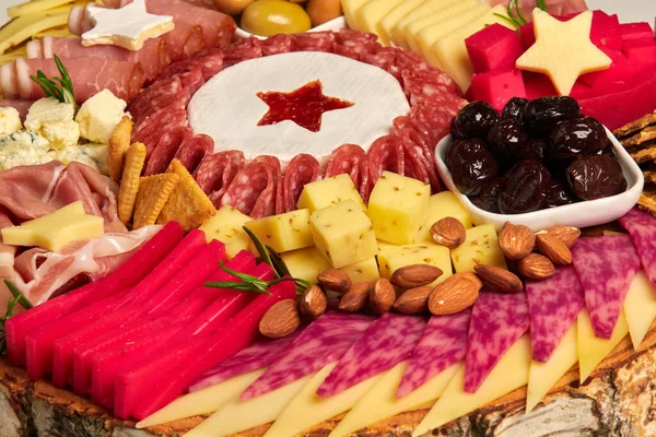 Appetizers boards with assorted cheese, salami, ham, olives and nuts. Charcuterie and cheese platter for Christmas dinner