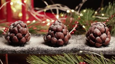 Şef, ladin ya da çam kozalağı şeklinde el yapımı çikolatalı keklere şeker serpti. Noel ve yeni yıl için güzel pişmiş yiyecekler.