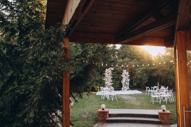 Kemer ve beyaz sandalyeli düğün töreni.