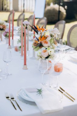 Çiçekler ve mumlarla düğün masası.