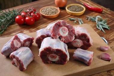 raw pork meat with spices and herbs on wooden board