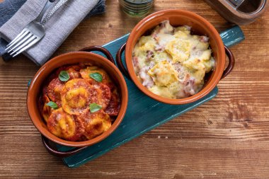 chicken breast with cheese and vegetables in a ceramic dish on a wooden background. selective focus.