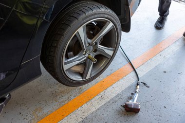 Where brake pads and tires are changed at an automobile repair shop