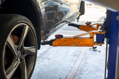 Where brake pads and tires are changed at an automobile repair shop