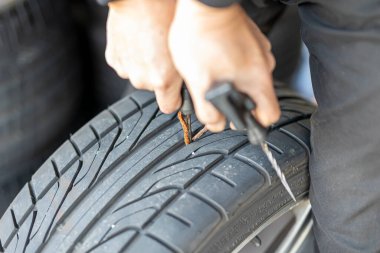 Where brake pads and tires are changed at an automobile repair shop