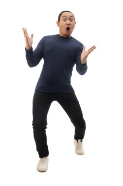 Man wearing casual blue shirt black denim and white shoes, excited surprised shocked with mouth open looking at camera, amazed wow espression. Full body portrait isolated cut out