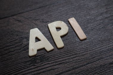 API Application Program Interface, text words typography written with wooden letter on black background, life and business motivational inspirational concept