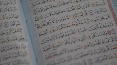 Close up of an opened Quran page, holy book of islam religion, reading Al Quran in ramadan
