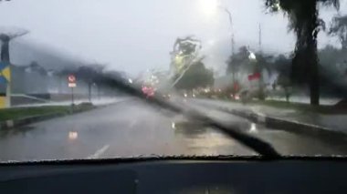 Car trip during heavy rain, passenger or driver POV, road journey transportation in stormy day