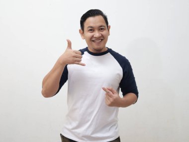 Call me gesture, happy smiling asian male make phone sign with his fingers, against white background