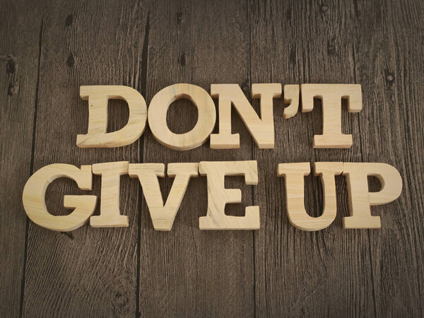 Don't give up, text words typography written with wooden letter, life and business motivational inspirational concept