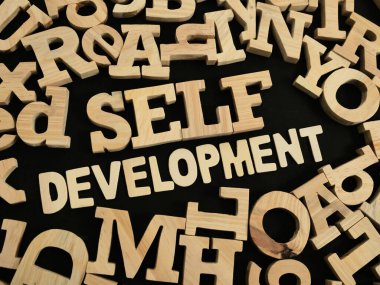 Self development, text words typography written with wooden letter, life and business motivational inspirational concept