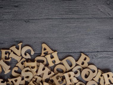 A closeup photograph of a variety of different typefaces in wooden letterpress with negative copy space